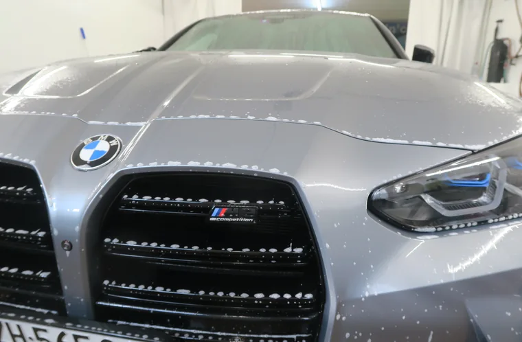 Handwashing the front of a BMW at AVP Autopflege