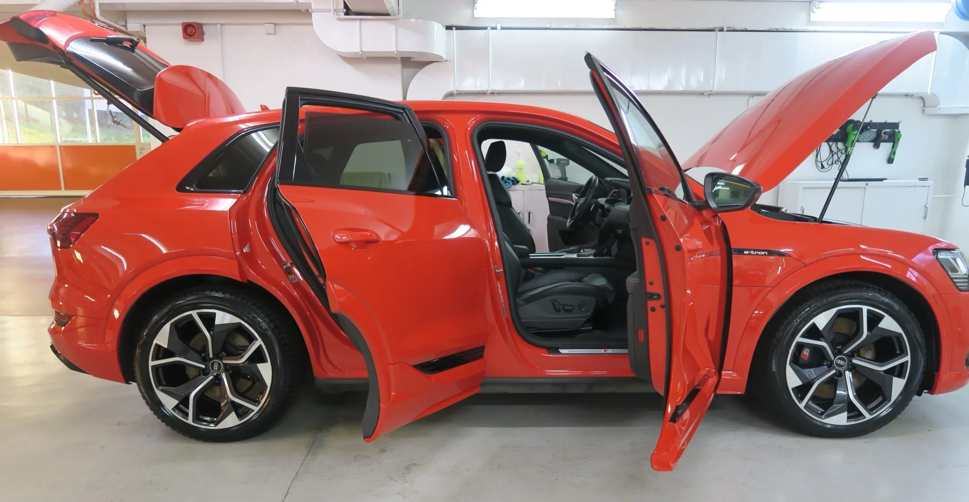 Red Audi e-tron with open doors in the AVP workshop