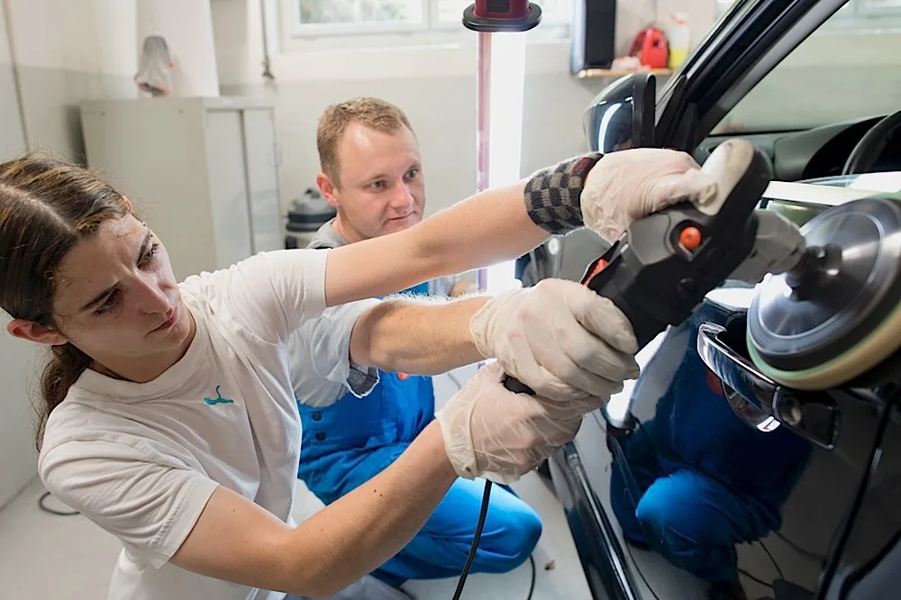Machine polishing dark vehicle paint at AVP Autopflege